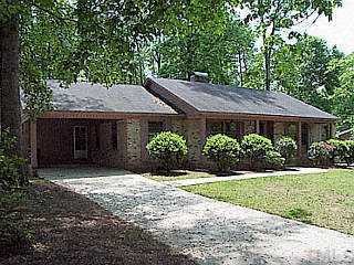 6409 Wrenwood Avenue Raleigh, NC 27607 - Photo 1 of 1 a house with a tree in front of it