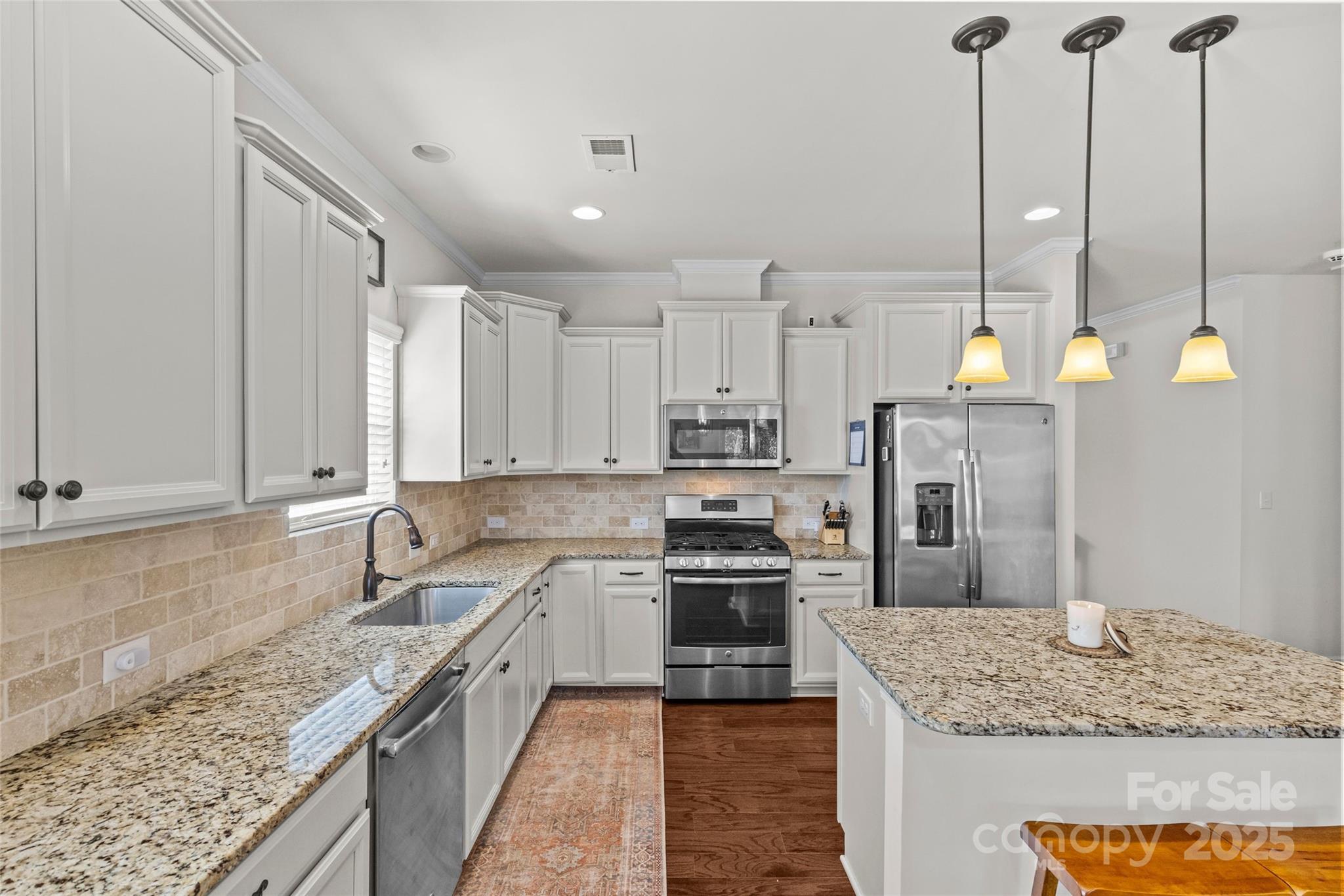 5828 Eleanor Rigby Road Charlotte, NC 28278 - Photo 12 of 39 a kitchen with stainless steel appliances granite countertop sink stove and refrigerator