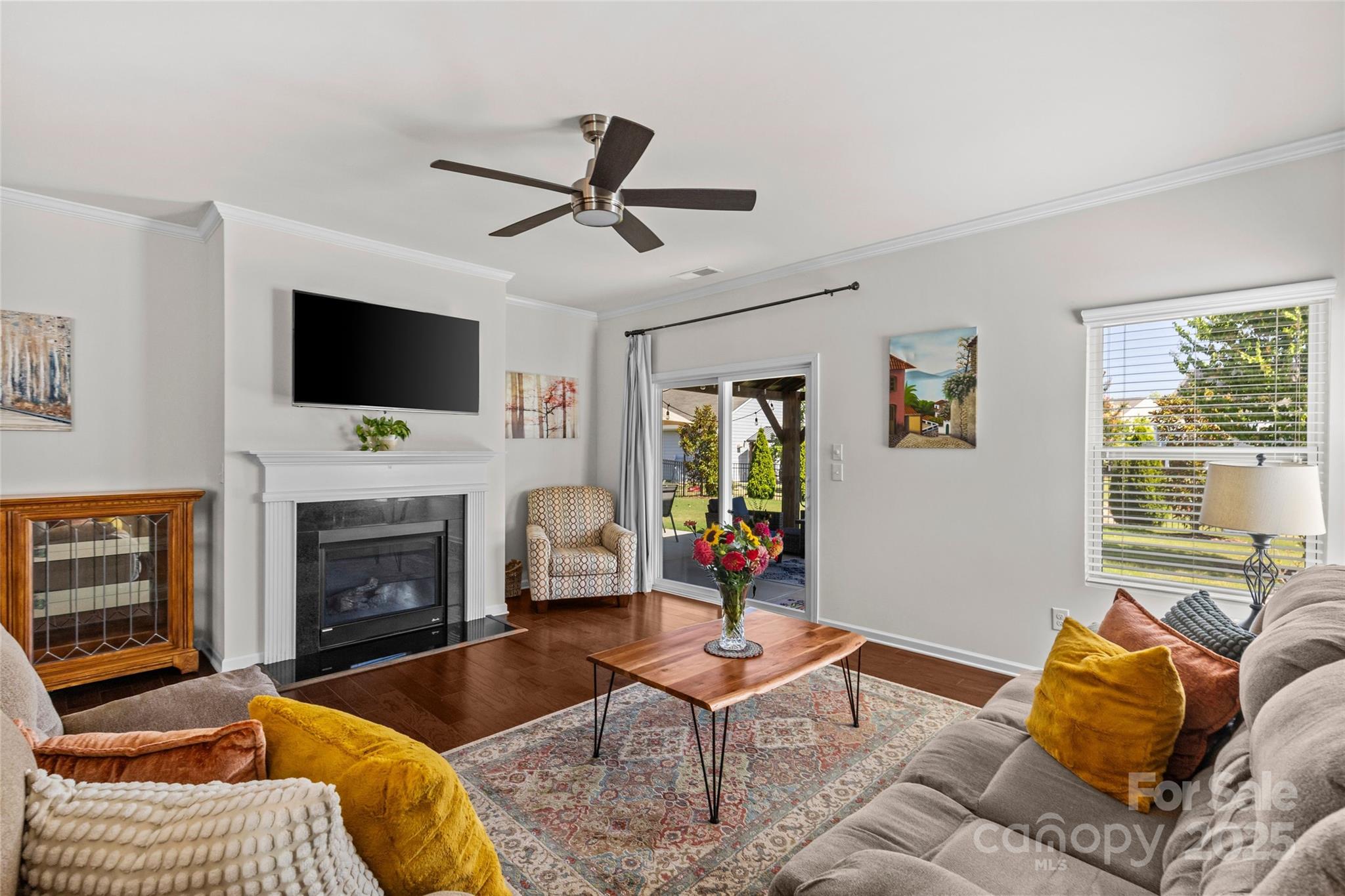 5828 Eleanor Rigby Road Charlotte, NC 28278 - Photo 13 of 39 a living room with furniture a fireplace and a flat screen tv