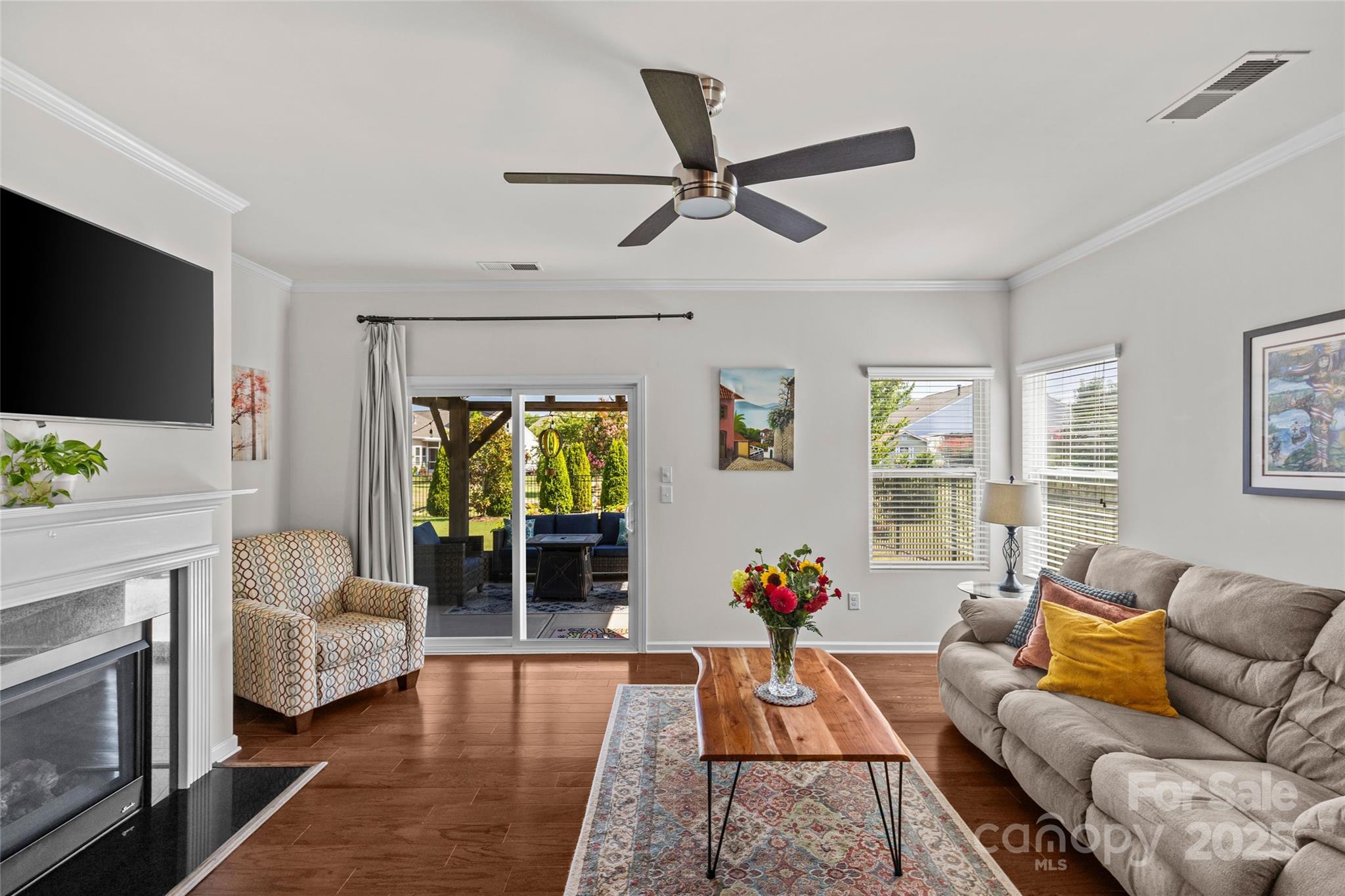 5828 Eleanor Rigby Road Charlotte, NC 28278 - Photo 14 of 39 a living room with furniture a flat screen tv and a fireplace
