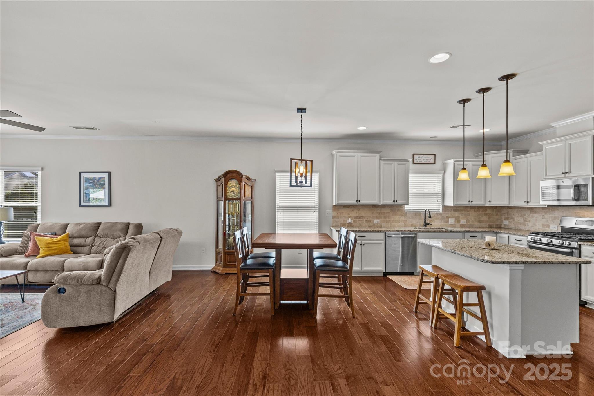 5828 Eleanor Rigby Road Charlotte, NC 28278 - Photo 15 of 39 a kitchen with a table chairs stove and wooden floor