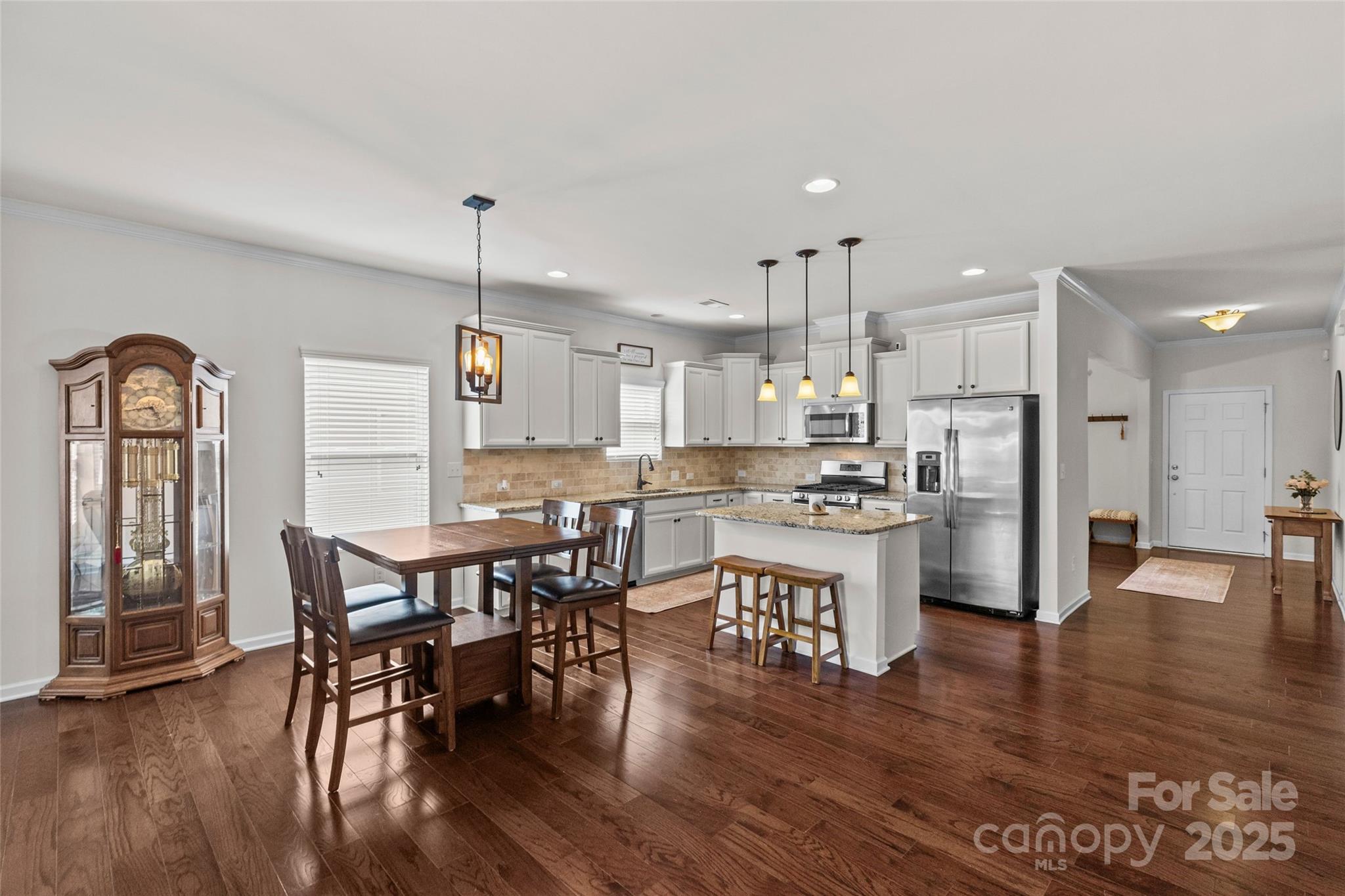 5828 Eleanor Rigby Road Charlotte, NC 28278 - Photo 18 of 39 a kitchen with stainless steel appliances kitchen island granite countertop a dining table chairs and granite counter tops