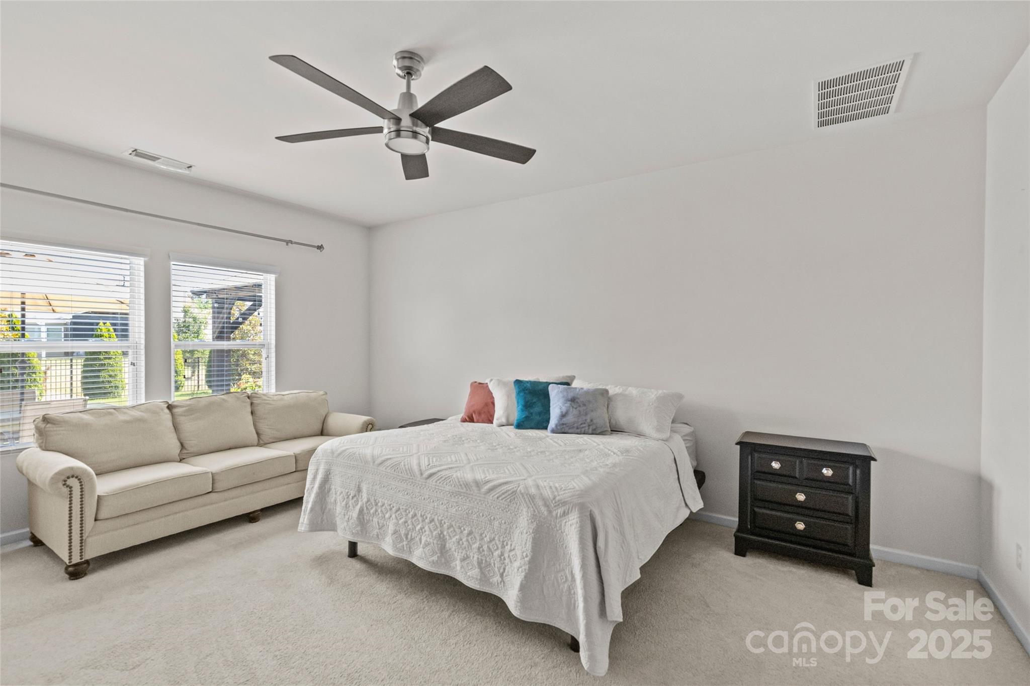 5828 Eleanor Rigby Road Charlotte, NC 28278 - Photo 21 of 39 a bedroom with a bed a couch and a large window