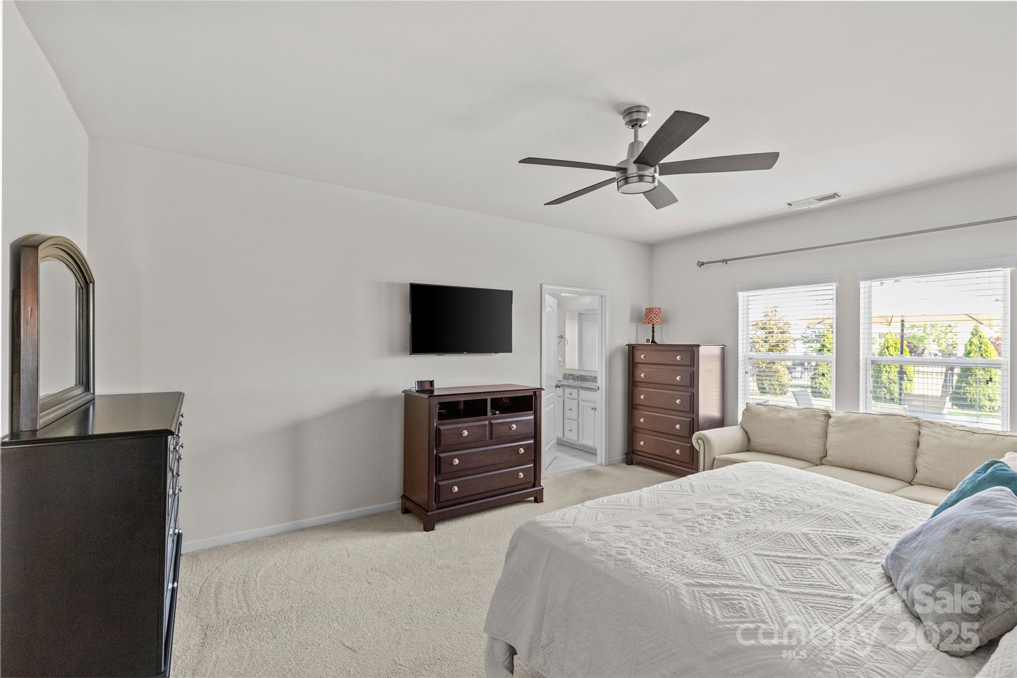 5828 Eleanor Rigby Road Charlotte, NC 28278 - Photo 24 of 39 a bedroom with a bed and a flat screen tv