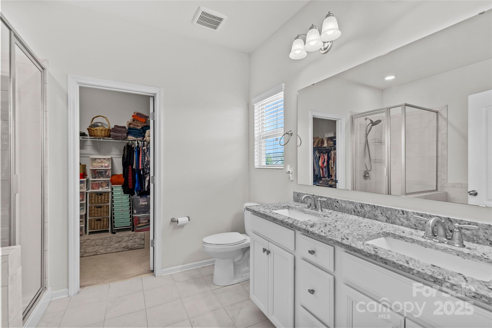 5828 Eleanor Rigby Road Charlotte, NC 28278 - Photo 25 of 39 a bathroom with a granite countertop sink a toilet and a mirror