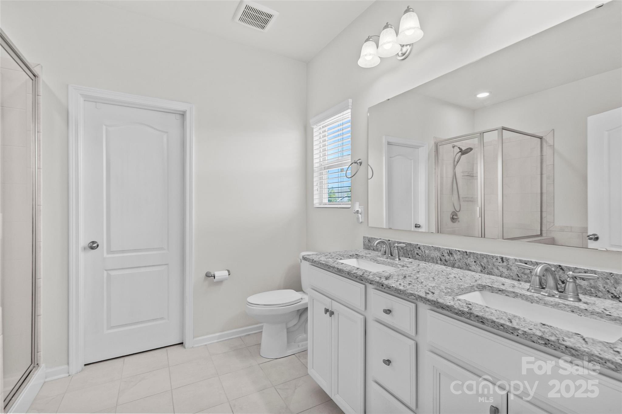 5828 Eleanor Rigby Road Charlotte, NC 28278 - Photo 26 of 39 a bathroom with a granite countertop sink a toilet and mirror