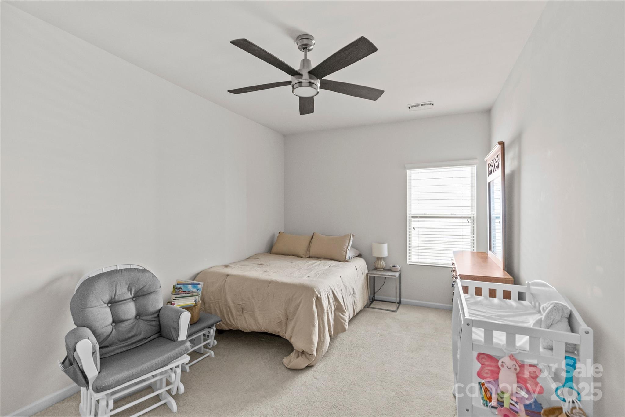 5828 Eleanor Rigby Road Charlotte, NC 28278 - Photo 30 of 39 a bedroom with a bed and a chandelier