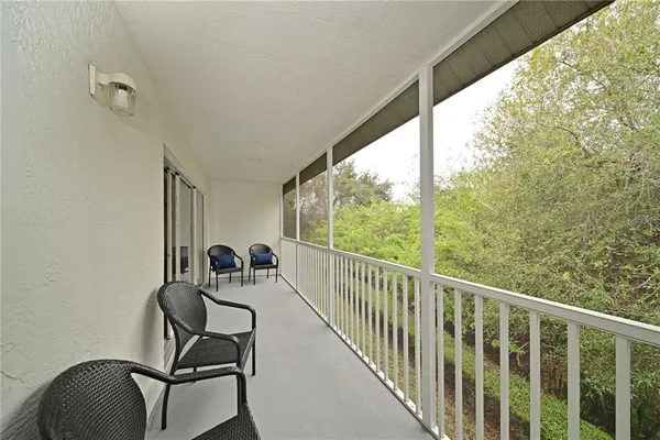a view of a balcony with chairs