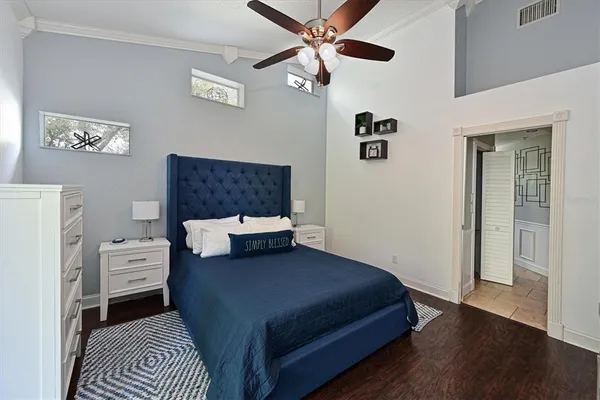 a bedroom with a bed and a chandelier