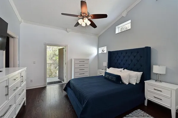 a bedroom with a bed and a chandelier