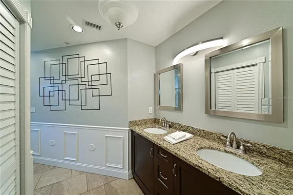 a bathroom with a granite countertop sink mirror and double