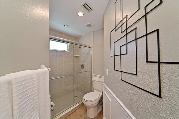 a white toilet sitting next to a bathroom sink