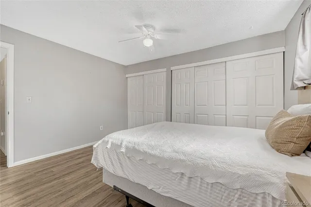 a bedroom with a bed and a ceiling fan