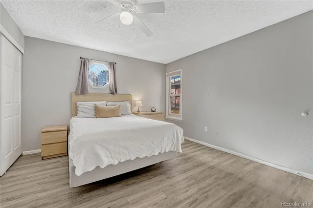 a bedroom with a bed and a painting on the wall