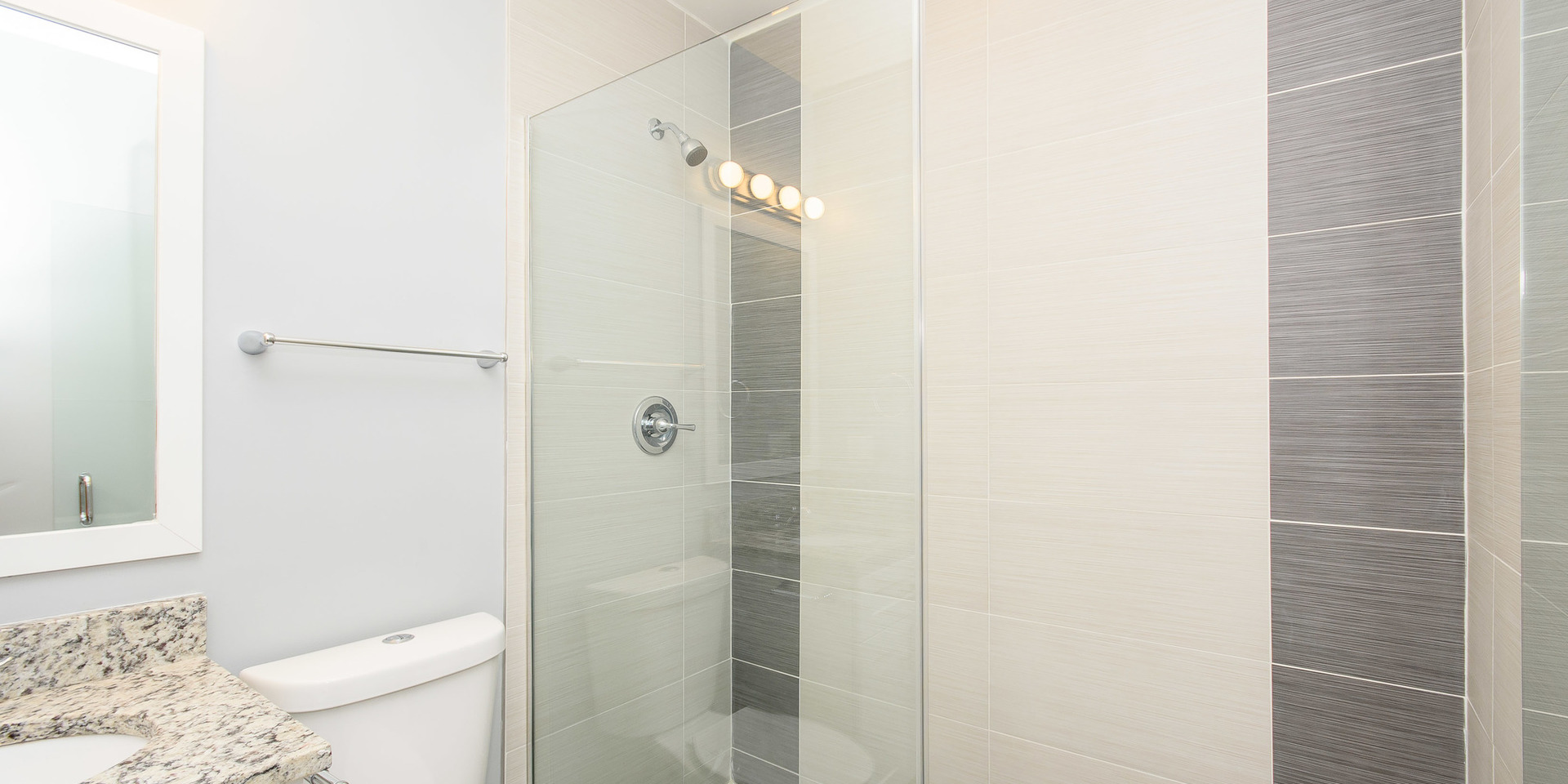 2163 North Bell Avenue, Unit 2F Chicago, IL 60647 - Photo 9 of 12 a bathroom with a granite countertop shower and a toilet