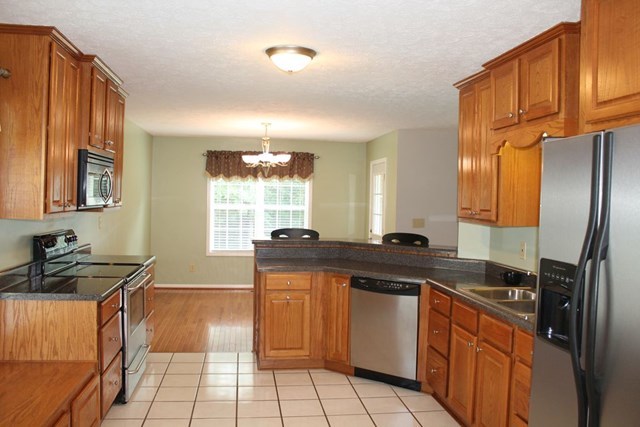 2017 Dames Ferry Road Forsyth, GA 31029 - Photo 4 of 22 a kitchen with stainless steel appliances granite countertop a sink stove and refrigerator