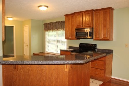 2017 Dames Ferry Road Forsyth, GA 31029 - Photo 5 of 22 a kitchen with granite countertop wooden cabinets a sink and a window