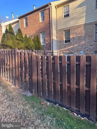 a view of a house with a wooden fence