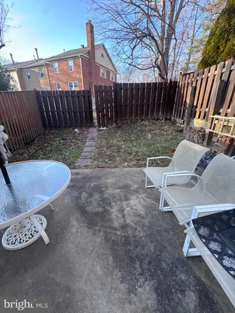 a view of a backyard with furniture and a yard