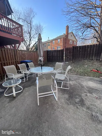 a view of a patio with a table and chairs