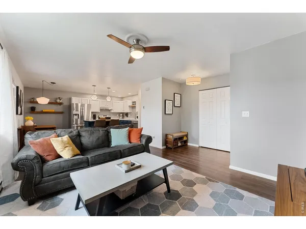 a living room with furniture and kitchen view