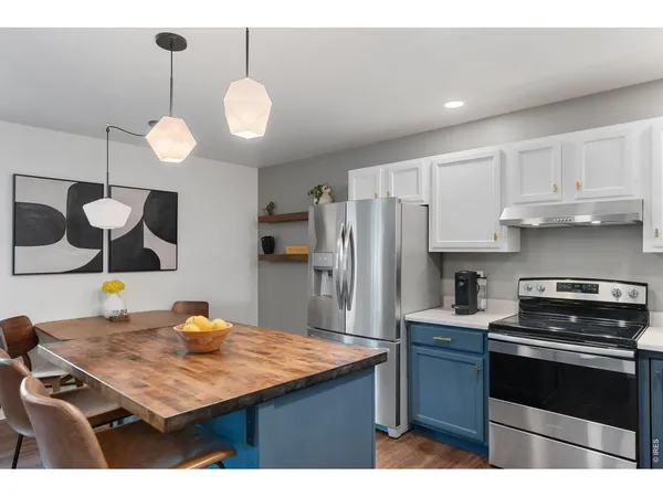 a kitchen with cabinets and stainless steel appliances