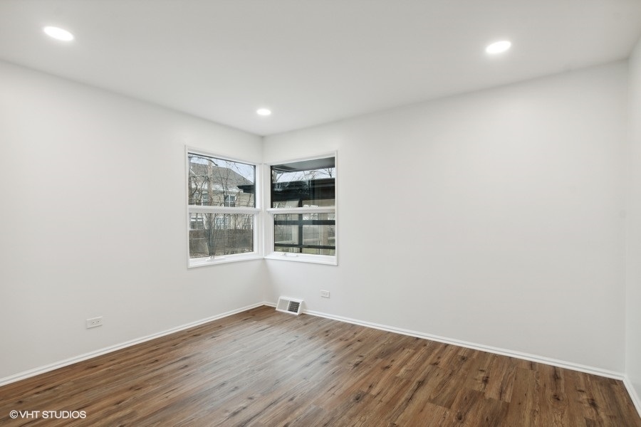 1232 Warrington Road Deerfield, IL 60015 - Photo 11 of 17 an empty room with wooden floor and windows