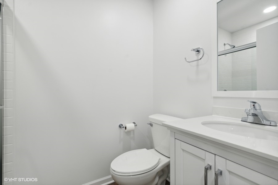 1232 Warrington Road Deerfield, IL 60015 - Photo 13 of 17 a bathroom with a sink a toilet and a mirror