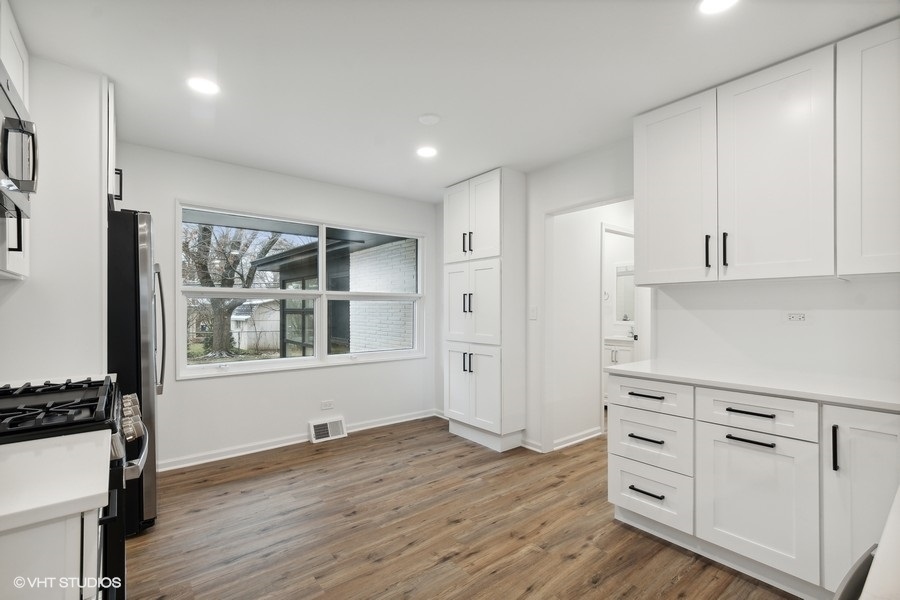 1232 Warrington Road Deerfield, IL 60015 - Photo 5 of 17 a view of a kitchen with wooden floor and cabinets