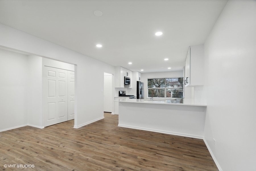 1232 Warrington Road Deerfield, IL 60015 - Photo 6 of 17 a view of a kitchen with wooden floor and a sink