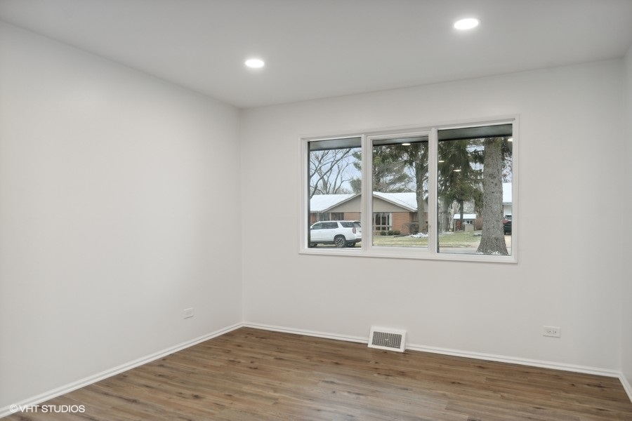 1232 Warrington Road Deerfield, IL 60015 - Photo 7 of 17 an empty room with wooden floor and a window