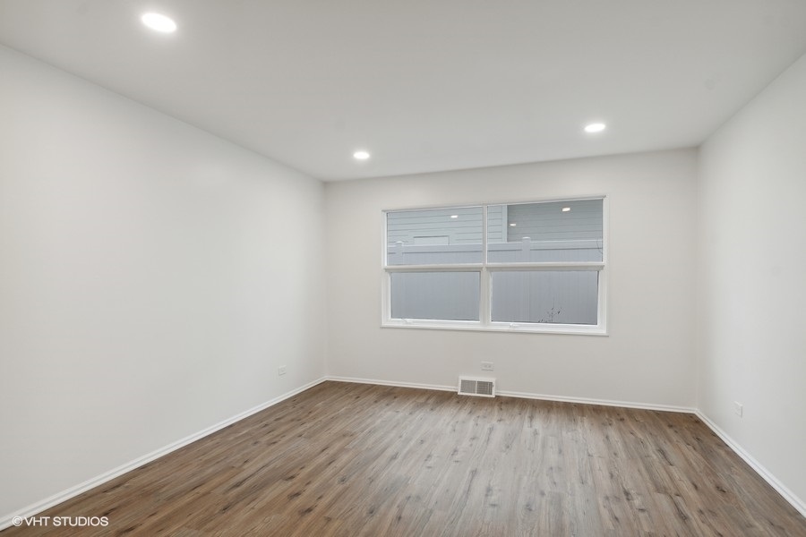 1232 Warrington Road Deerfield, IL 60015 - Photo 8 of 17 an empty room with wooden floor and windows
