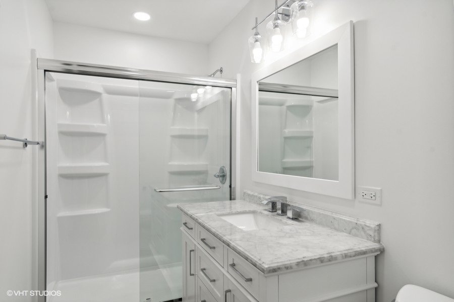 1232 Warrington Road Deerfield, IL 60015 - Photo 9 of 17 a bathroom with a granite countertop sink a mirror and a shower