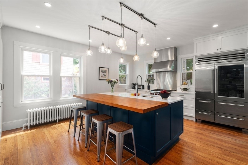 12 Zamora Street Boston, MA 02130 - Photo 11 of 28 a kitchen with stainless steel appliances granite countertop a sink a stove and a refrigerator