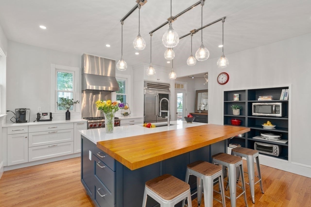 12 Zamora Street Boston, MA 02130 - Photo 12 of 28 a kitchen with stainless steel appliances granite countertop a sink and a stove