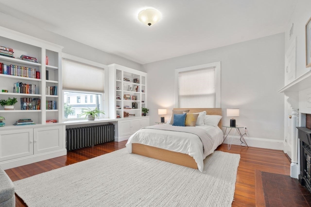 12 Zamora Street Boston, MA 02130 - Photo 13 of 28 a bedroom with a large bed and a wooden floor