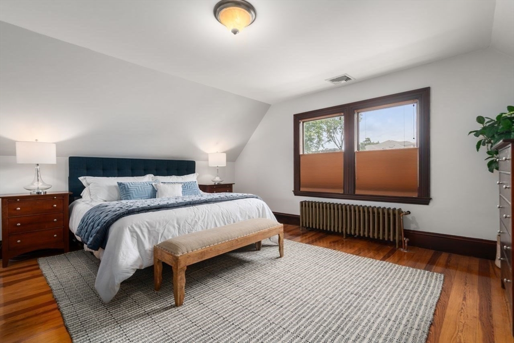 12 Zamora Street Boston, MA 02130 - Photo 16 of 28 a bedroom with a bed and wooden floor