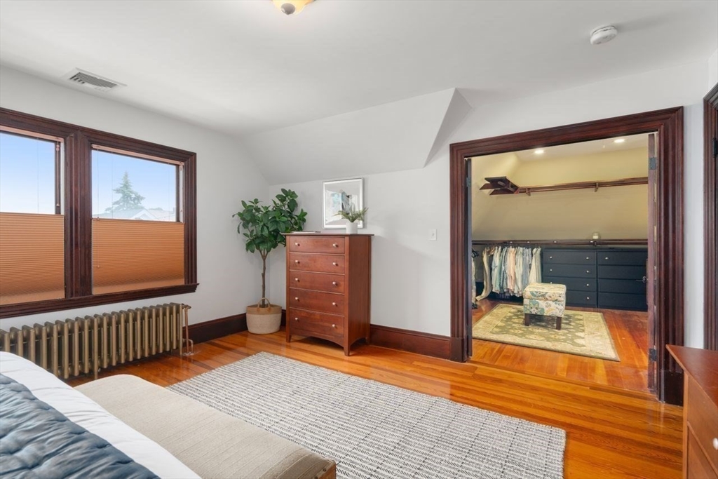 12 Zamora Street Boston, MA 02130 - Photo 17 of 28 a bedroom with a bed and wooden floor