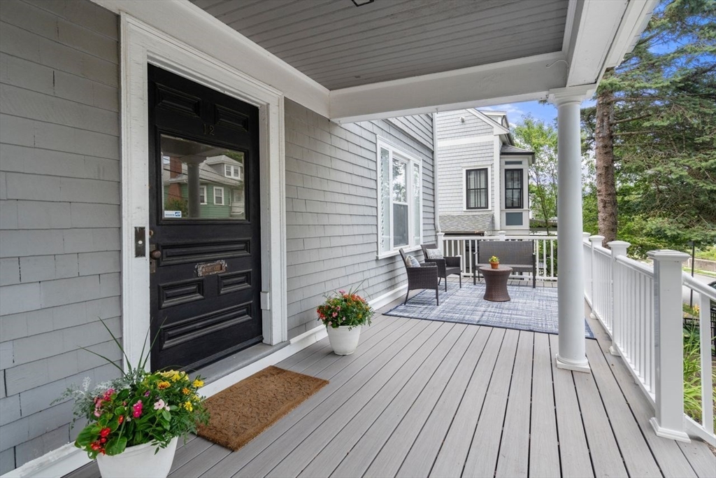 12 Zamora Street Boston, MA 02130 - Photo 2 of 28 a view of a deck with table and chairs and wooden floor