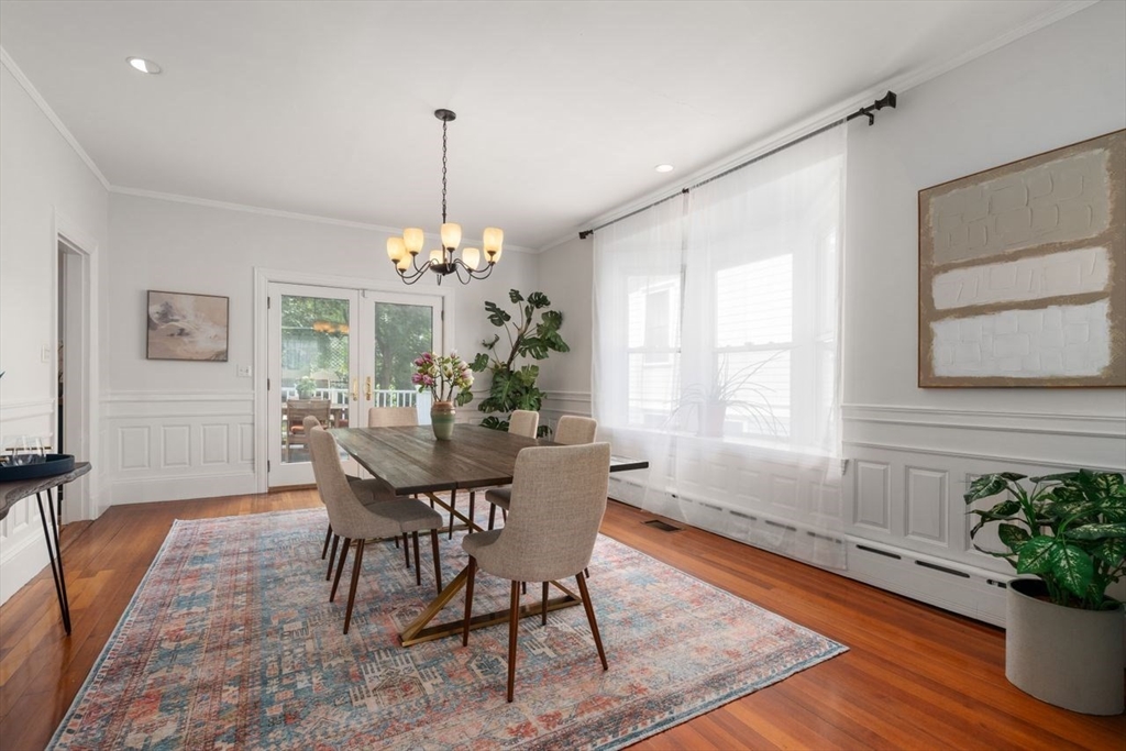 12 Zamora Street Boston, MA 02130 - Photo 8 of 28 a dining room with furniture a chandelier and wooden floor