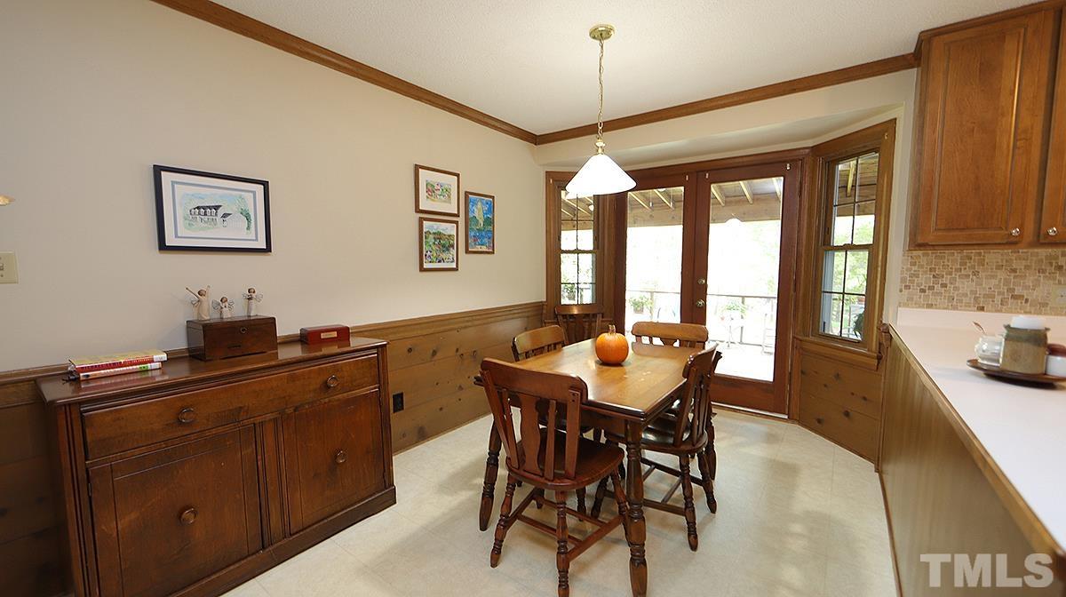 8816 Woodyhill Road Raleigh, NC 27613 - Photo 14 of 30 a view of a dining room with furniture window and outside view