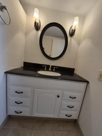 a bathroom with a sink a vanity and a mirror