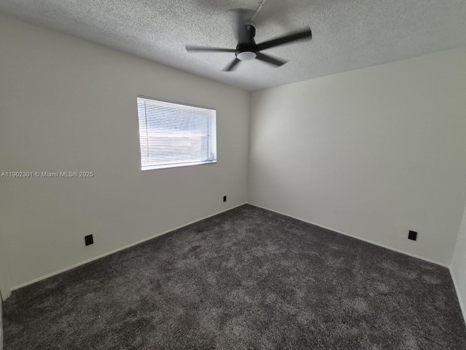 5100 Southwest 64th Avenue, Unit 201A Davie, FL 33314 - Photo 17 of 29 an empty room with a ceiling fan and window