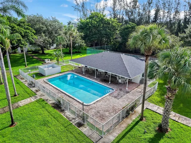 an aerial view of a house having patio with a yard