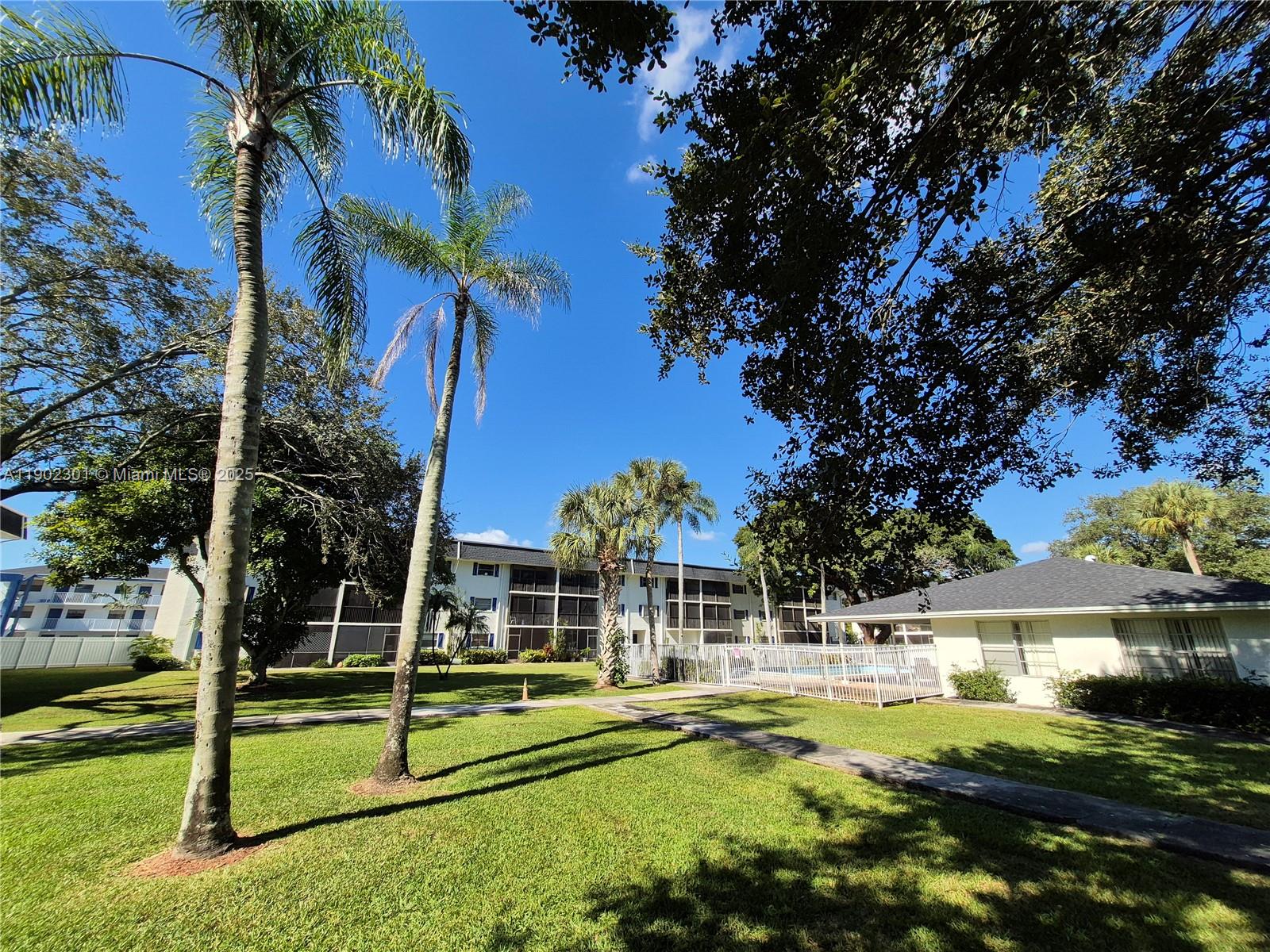 5100 Southwest 64th Avenue, Unit 201A Davie, FL 33314 - Photo 22 of 29 a view of a house with backyard and a tree