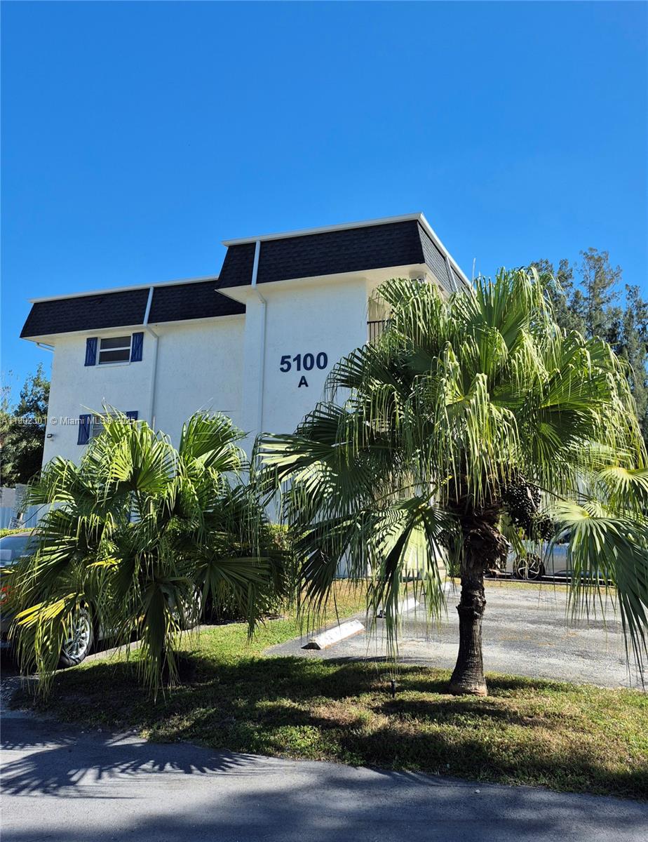 5100 Southwest 64th Avenue, Unit 201A Davie, FL 33314 - Photo 24 of 29 a palm tree sitting in front of a building
