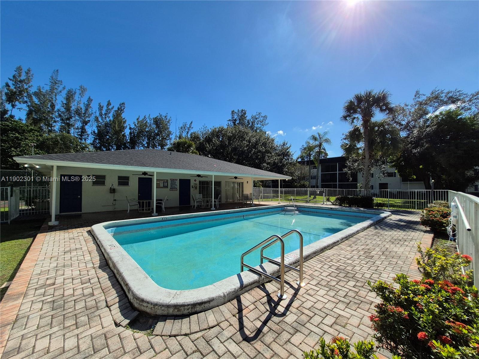 5100 Southwest 64th Avenue, Unit 201A Davie, FL 33314 - Photo 28 of 29 a view of a house with swimming pool and sitting area
