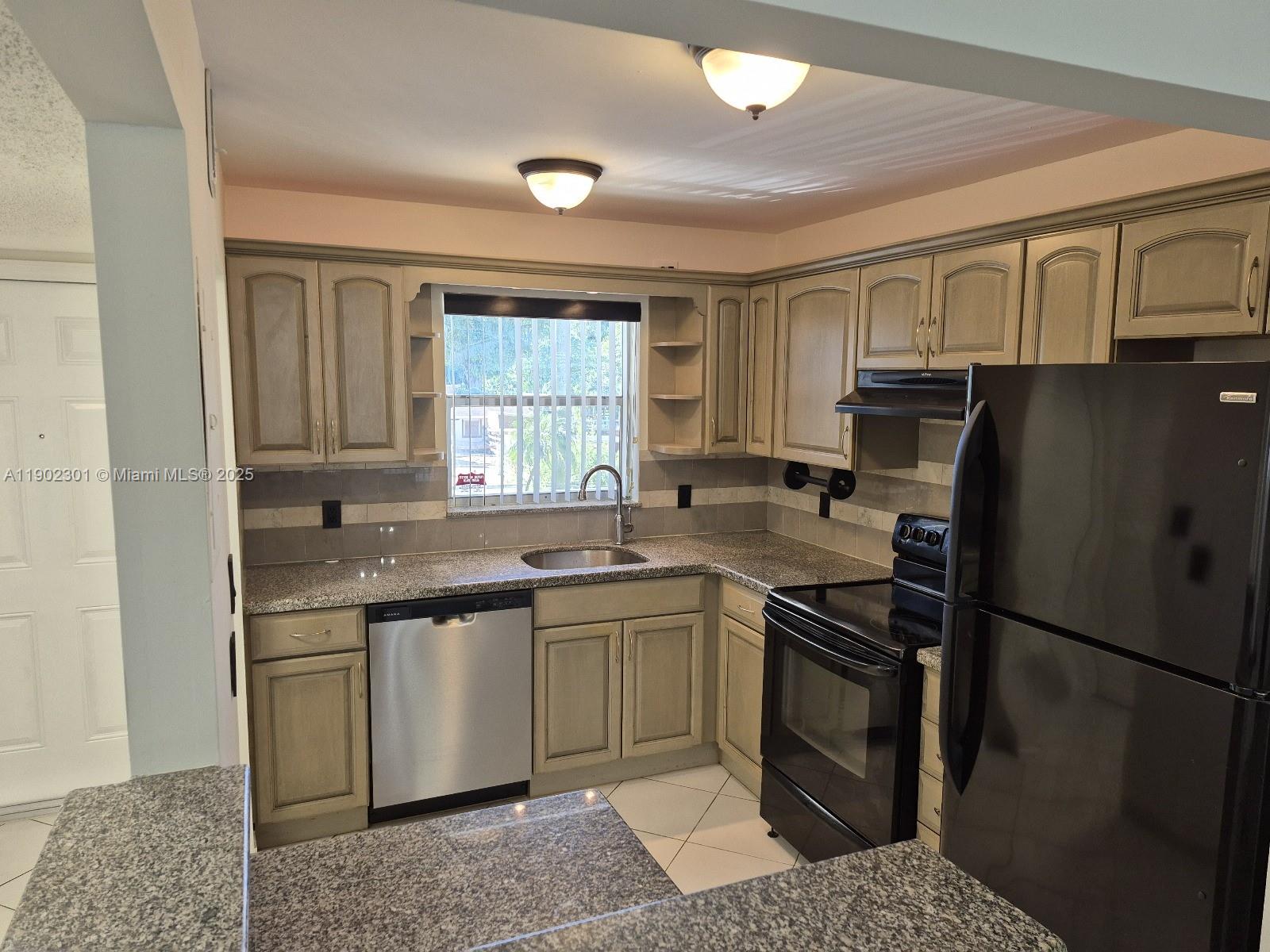 5100 Southwest 64th Avenue, Unit 201A Davie, FL 33314 - Photo 6 of 29 a kitchen with a sink stove and refrigerator