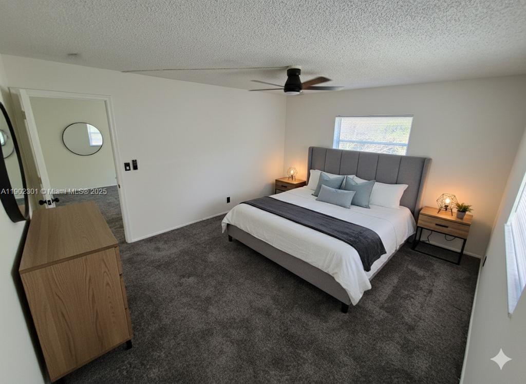 5100 Southwest 64th Avenue, Unit 201A Davie, FL 33314 - Photo 10 of 29 a bedroom with a bed and a dresser