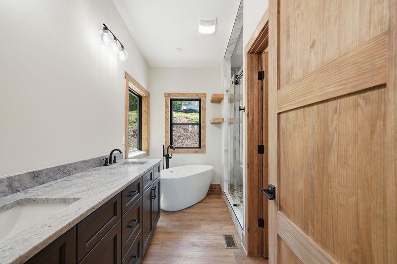 216 Old Orchard Road Ellijay, GA 30536 - Photo 36 of 59 a bathroom with a double vanity sink a mirror and a bathtub